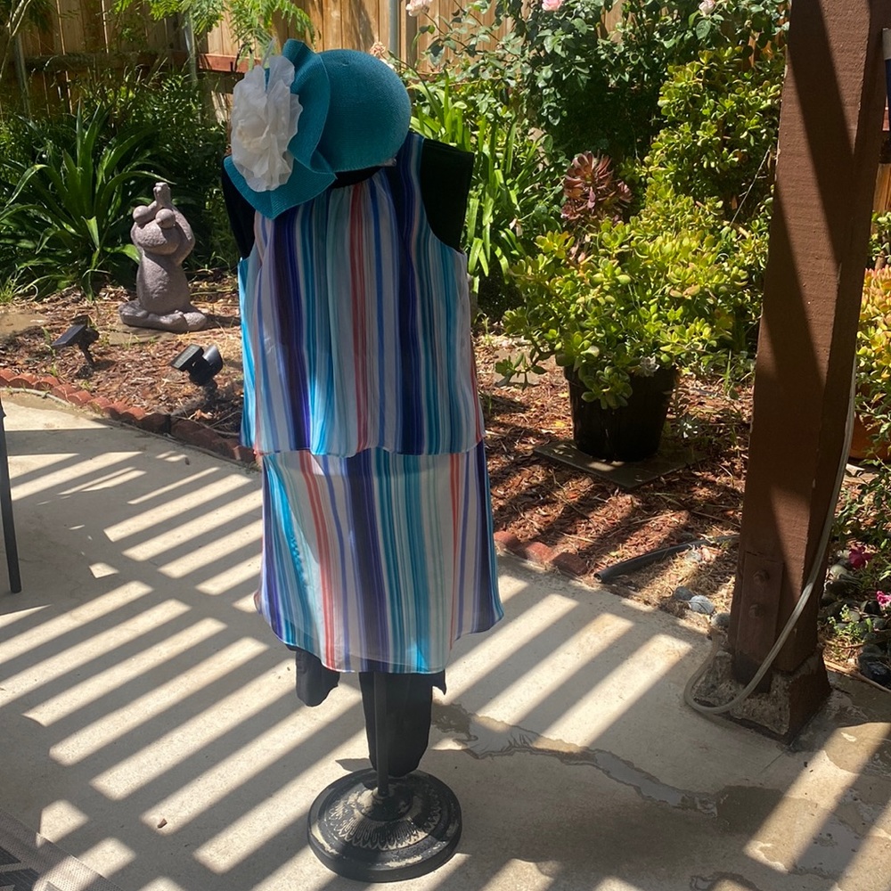 Multi colored sundress and structure turquoise hat designed by Sylvia.